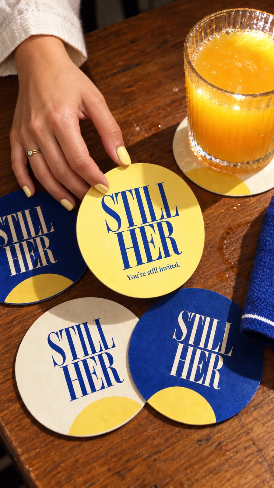STILL HER coasters beside a glass of orange juice